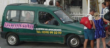 The van picks up passengers at the dock.